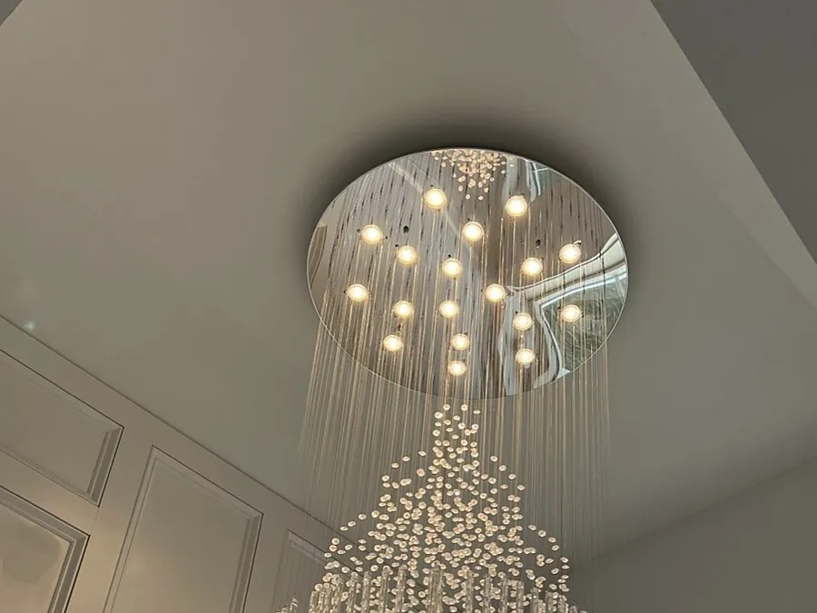 Large crystal chandelier installed in a two-story foyer
